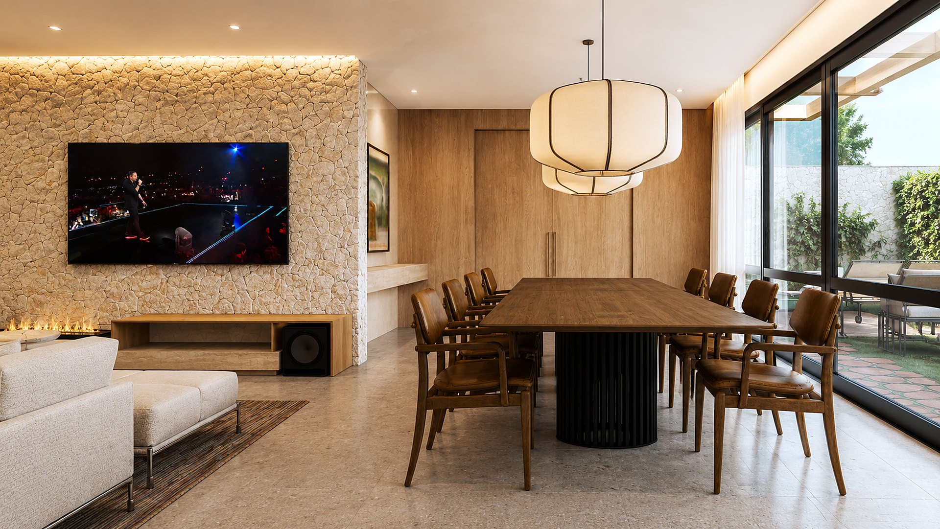 Living e sala de jantar integrados com parede de pedra, lareira e vista para o jardim – projeto de casa em condomínio no Alto da Boa Vista pela MWARQ